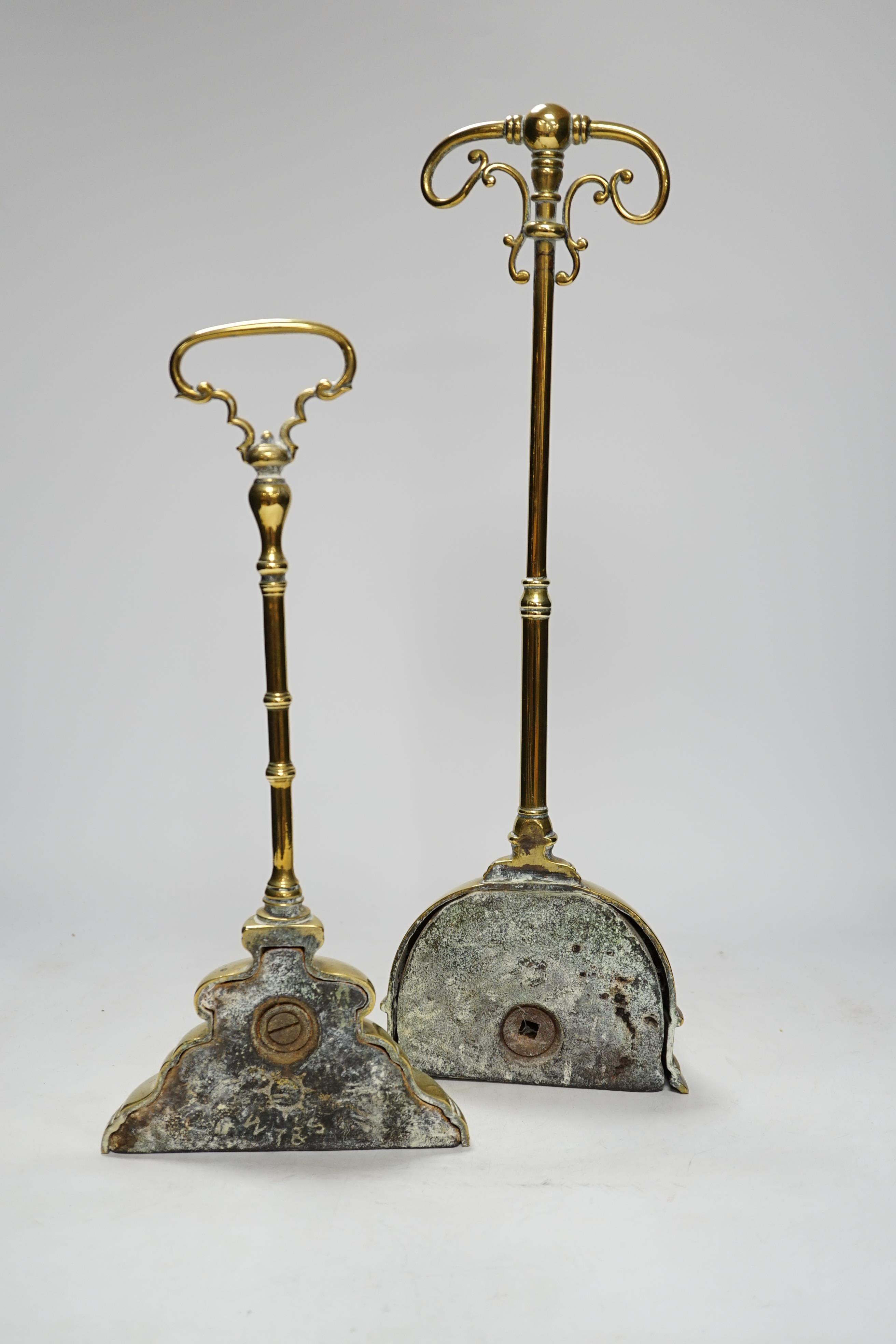 Two early 19th century cast brass door stops, with moulded stepped plinths, largest 45cm high